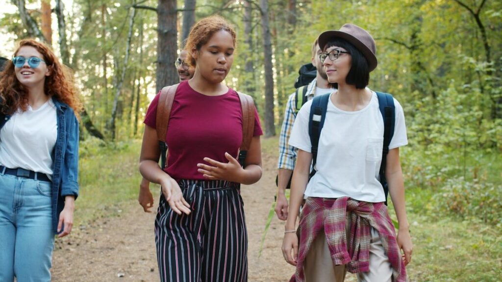 Group of friends hiking on a trail enjoying an active weekend instead of being sedentary