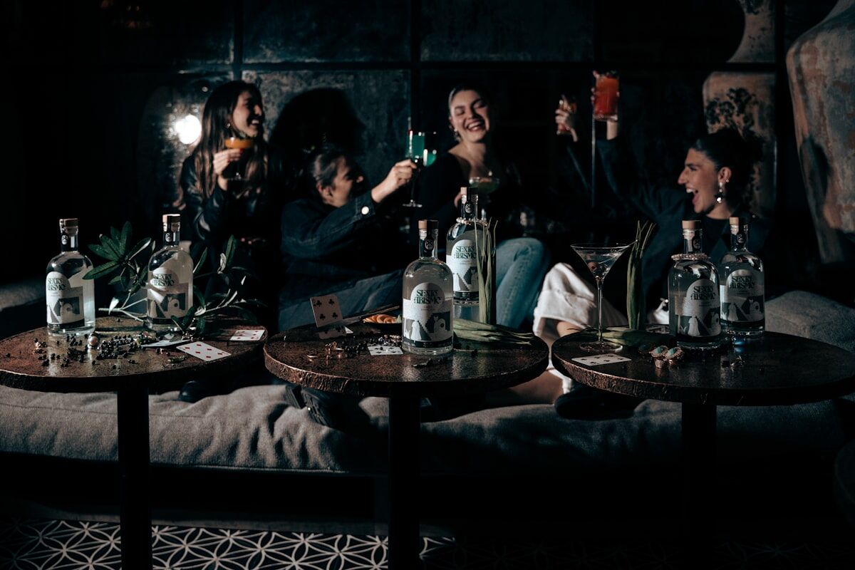 Friends gathering for a social dinner with drinks demonstrating balance