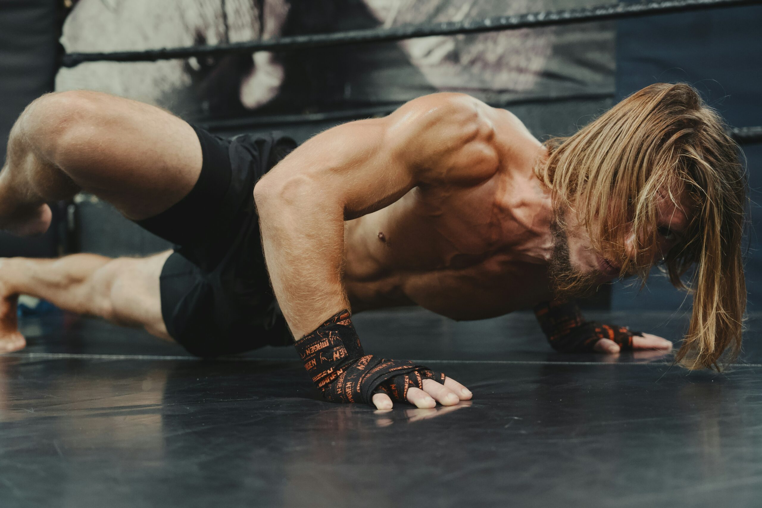 Muscular athlete performing push-ups for upper body hypertrophy workout