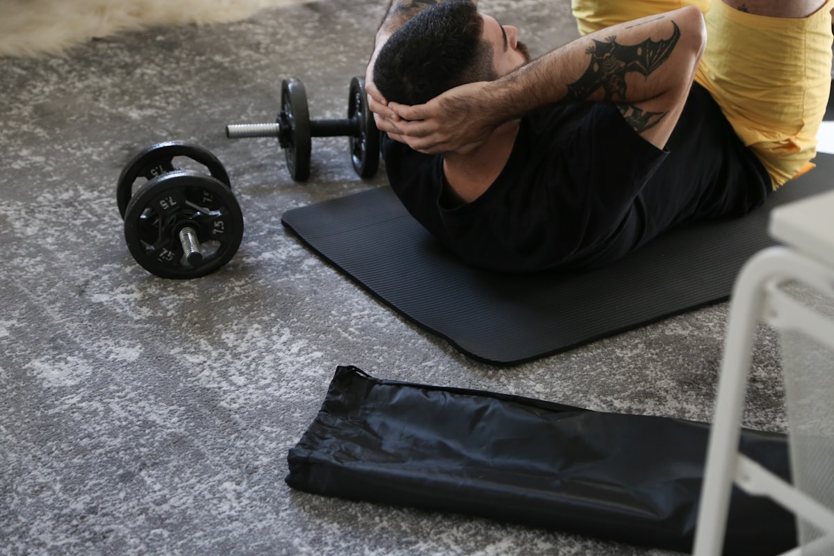 man is doing exercises on a mat with a barbell - strength training - fitness friday facts