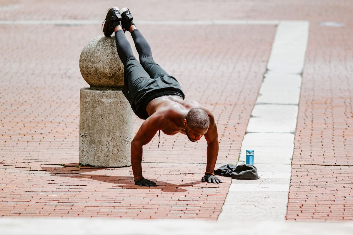 Man resting and sweating on gym floor after intense workout