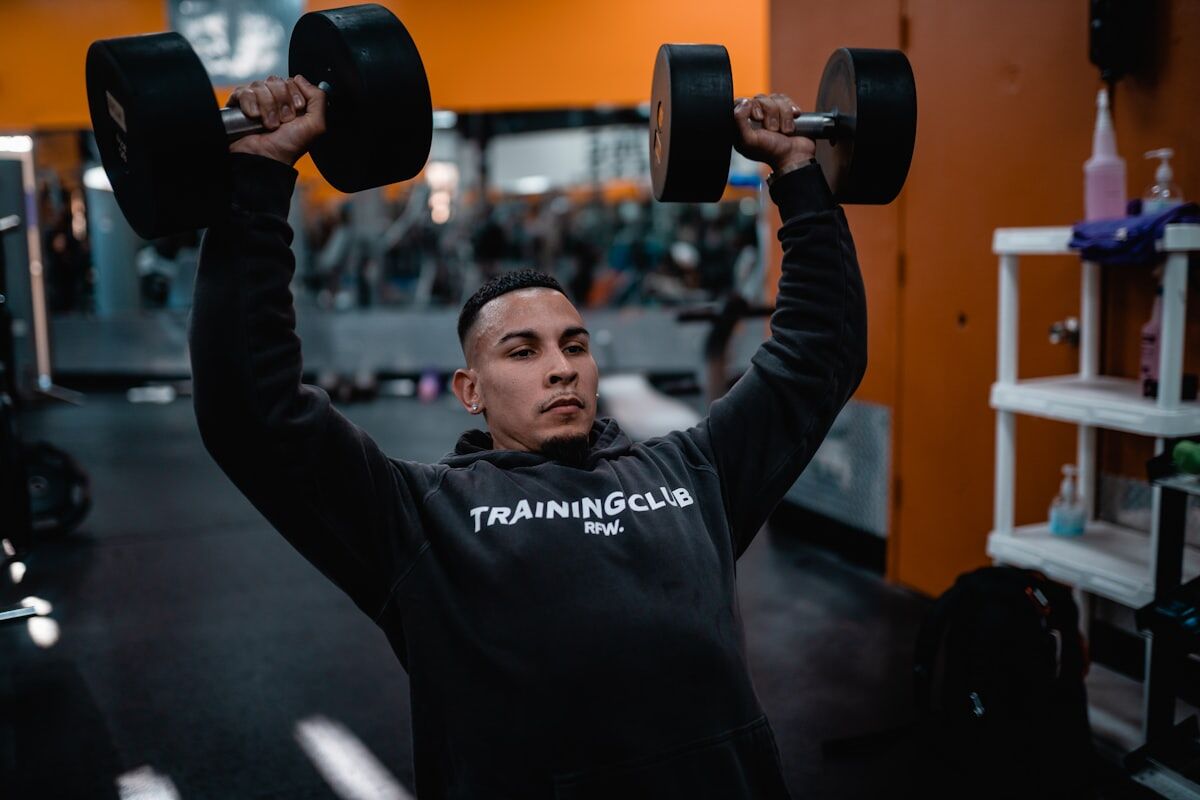 Man in black long sleeve shirt holding black dumbbell - Push Day Mastery