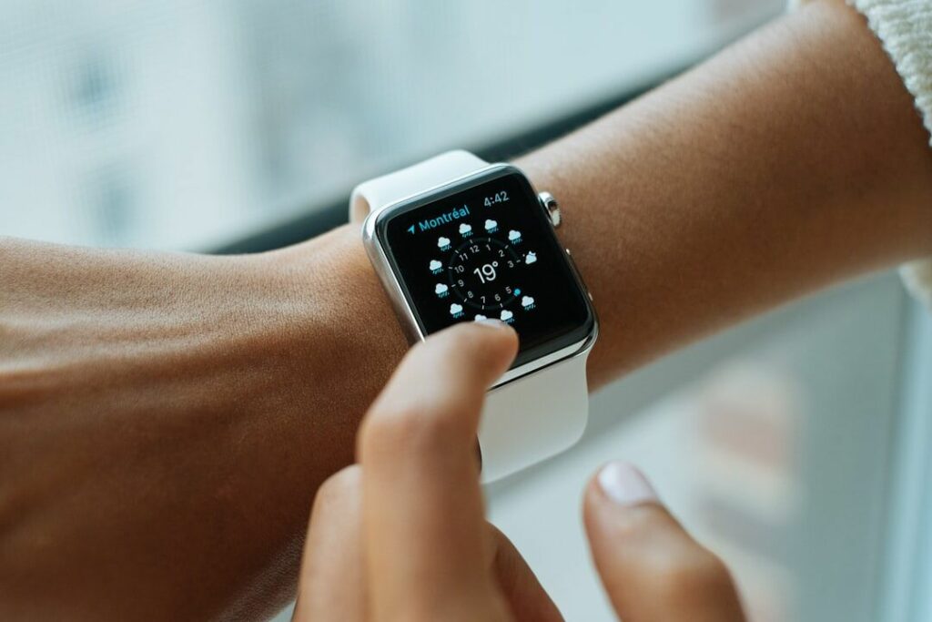 A person wearing an Apple Watch showing fitness analytics and workout activity rings