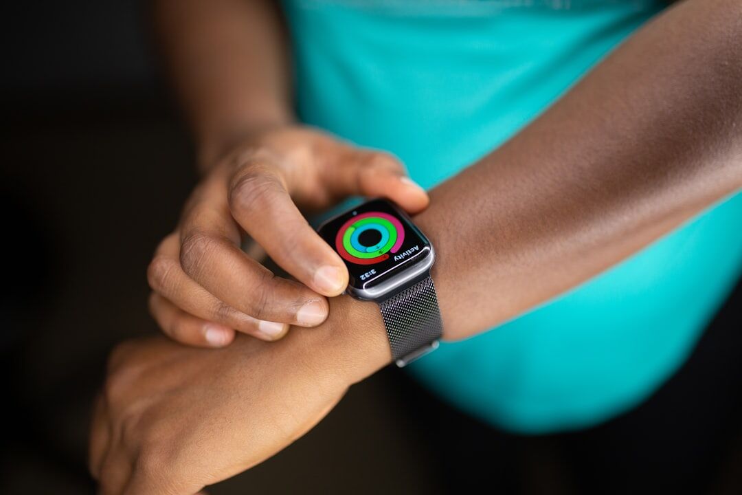A close-up of a person interacting with health and activity tracking metrics on a smartwatch