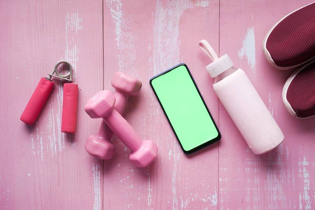 Smartphone with sports equipment representing stress and muscle recovery tracking with Body Journey
