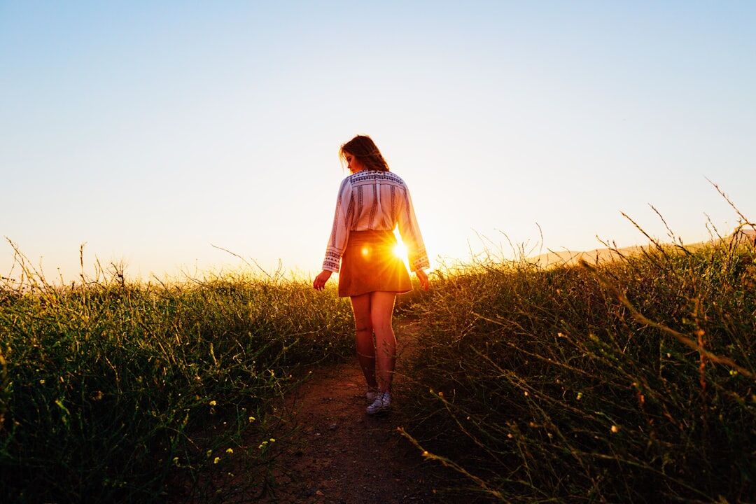 Active woman going for a morning walk on a sunlit path - weekend weight gain prevention