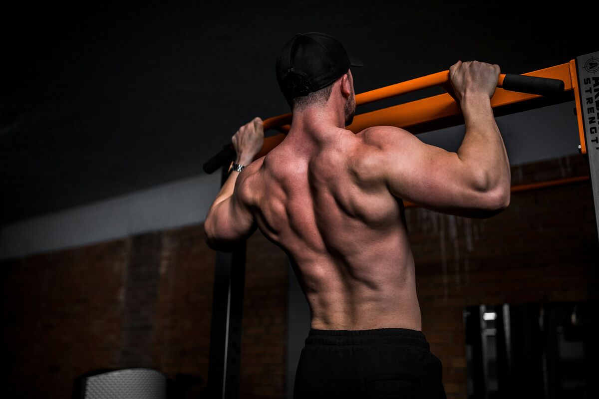Athlete performing pull ups for bodyweight progressive overload - fitness friday facts