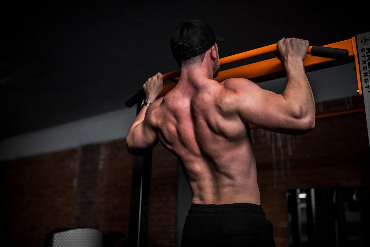 complete arm day workout - athlete performing cable tricep pushdown in the gym