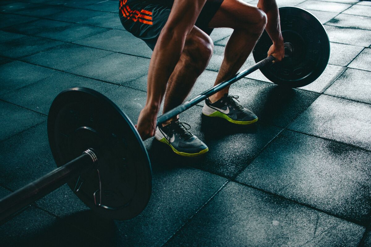 Athlete preparing for barbell progressive overload strength training - progressive overload myths