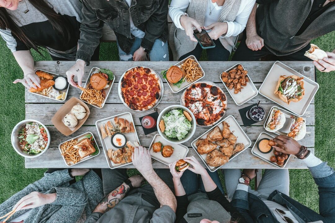 A group of friends sharing tapas and plates at a restaurant - dining out on a diet