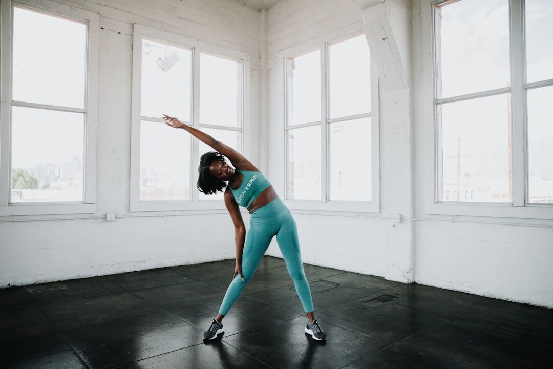 A person performing stretching before workout in the gym - fitness friday facts