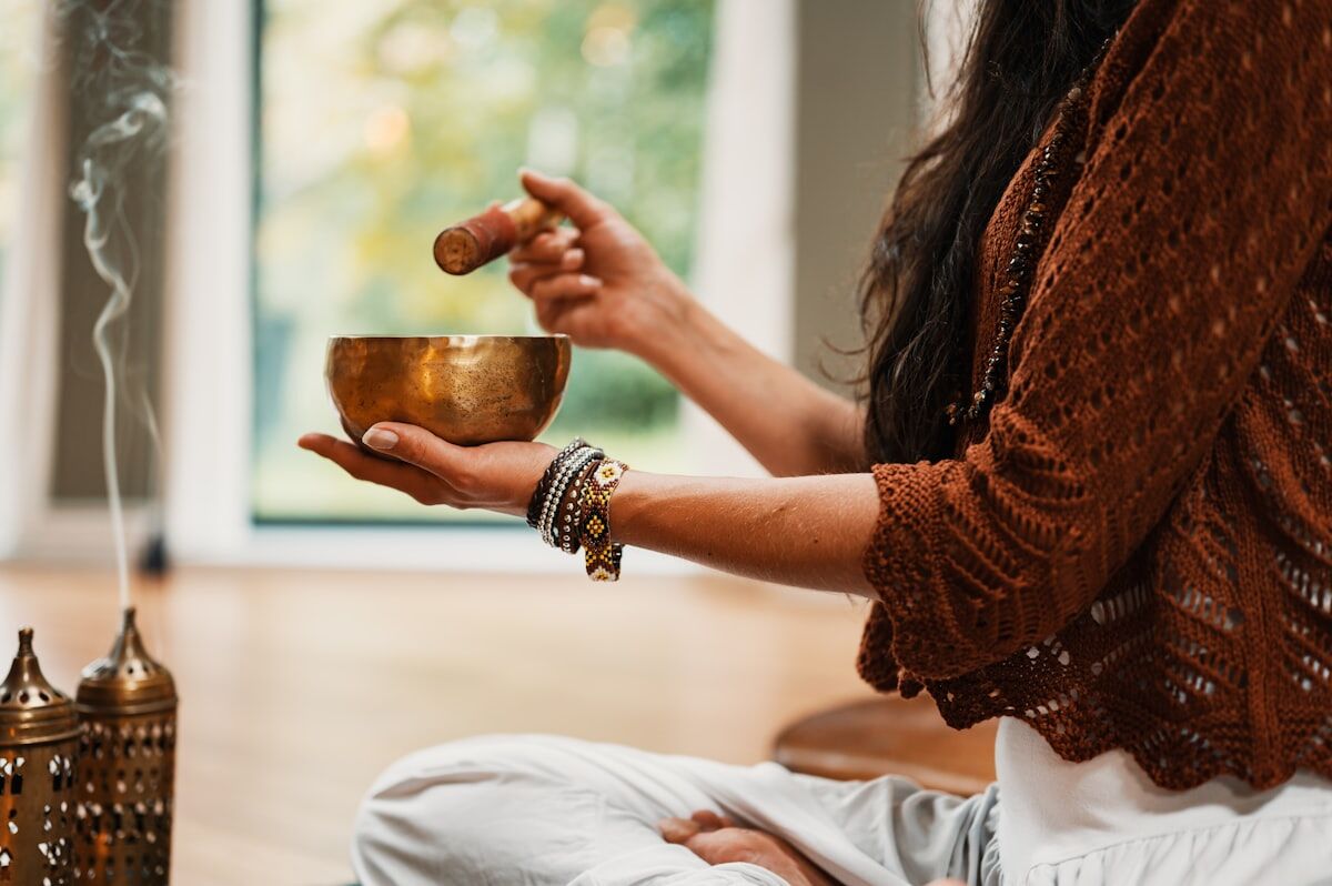 sleep and muscle recovery - a person holding a warm cup of herbal tea winding down before bed