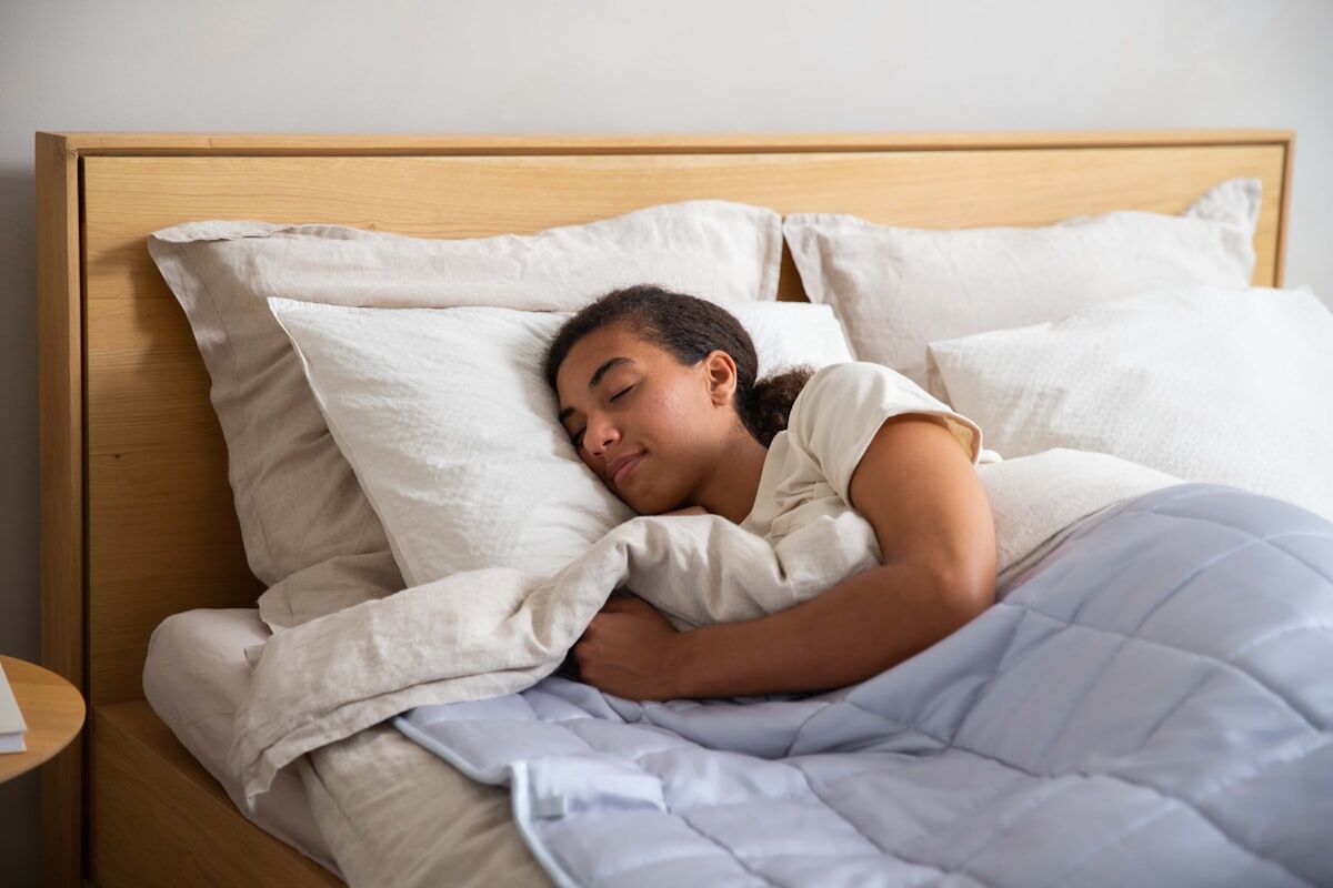 sleep and muscle recovery - a person sleeping peacefully in a comfortable bed with white sheets
