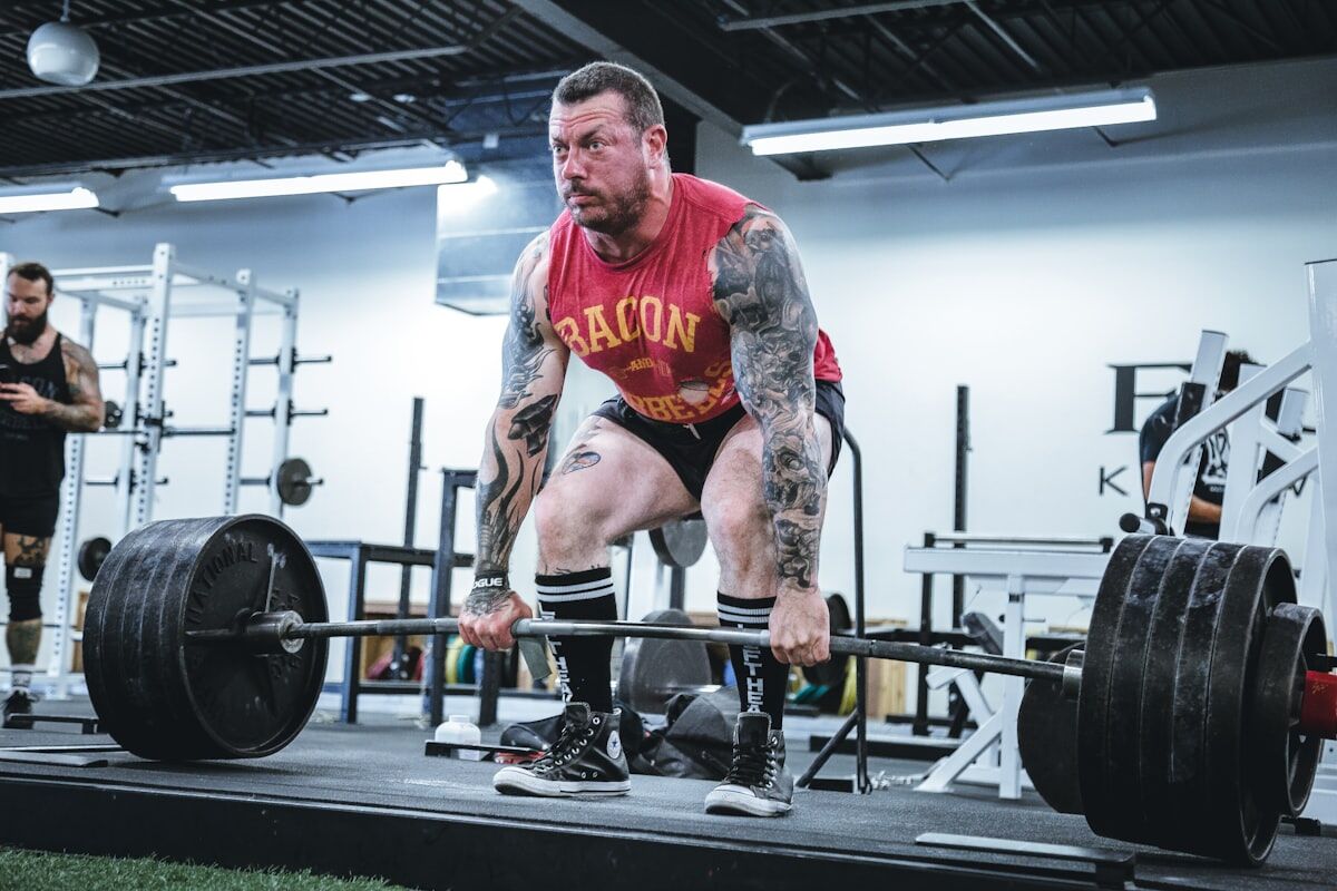 Close-up of a loaded barbell with weight plates - progressive overload training - fitness friday facts