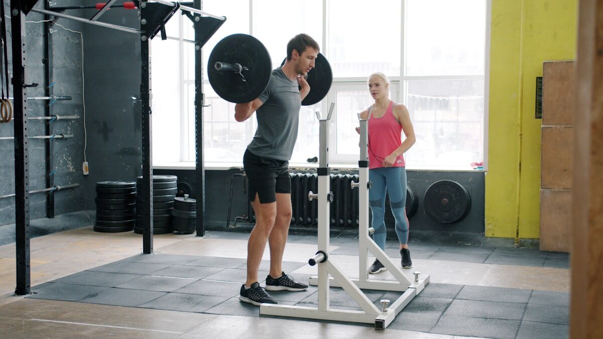 Athlete performing barbell back squat - quad focused leg day - workout wednesday
