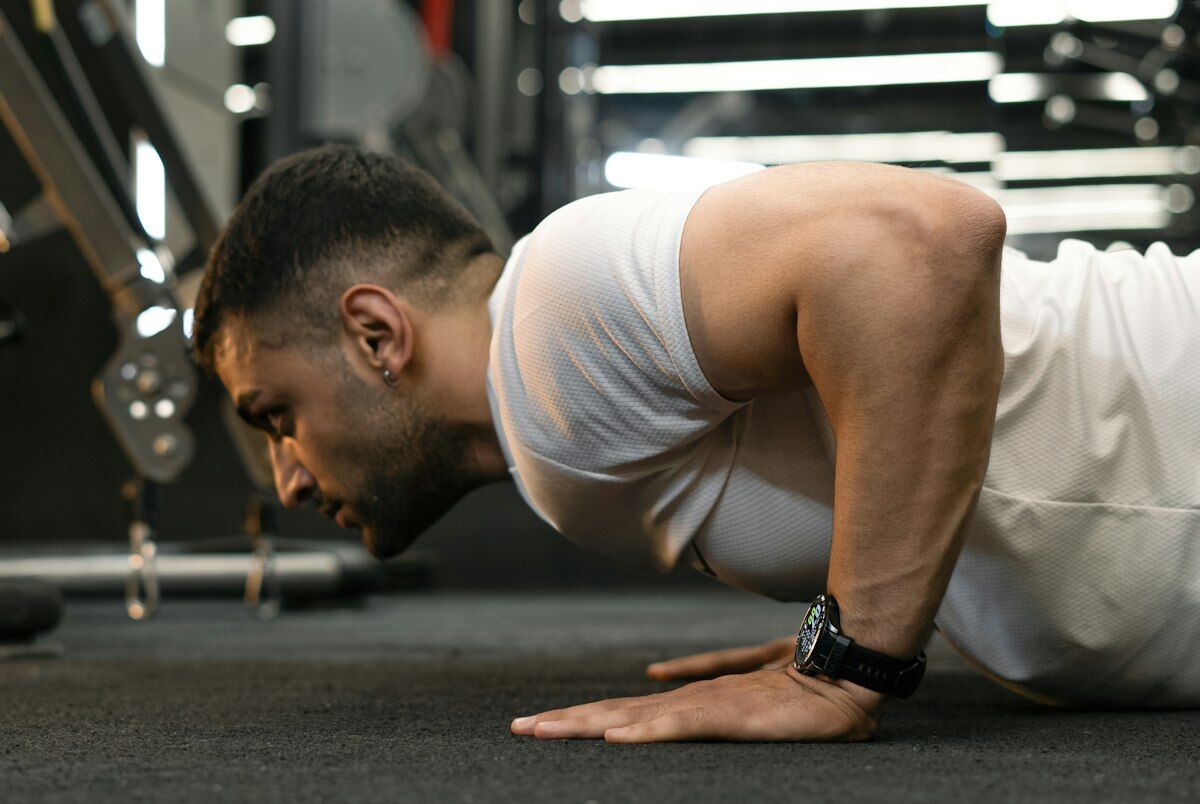 Man performing core stability hold in gym - complete core strength routine - workout wednesday