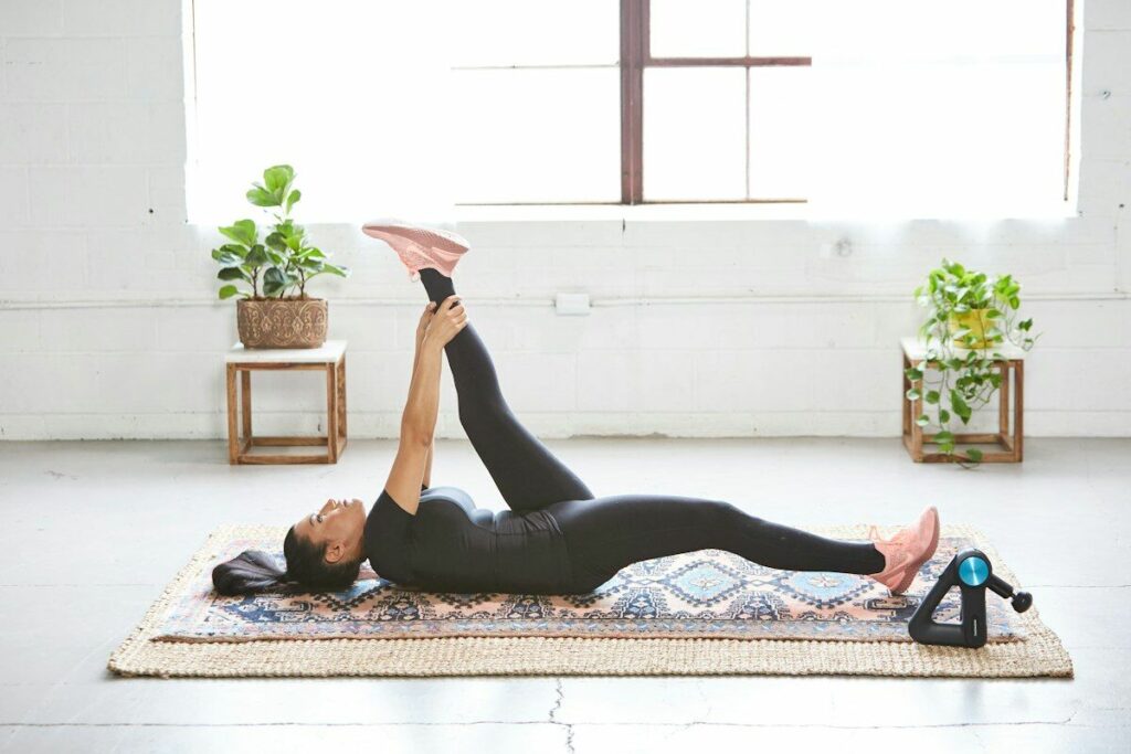 Woman stretching on floor - muscle soreness myths - fitness friday facts